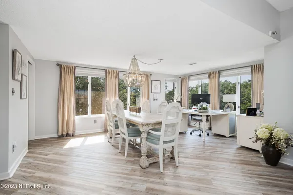 a view of a dining room with furniture window and wooden floor