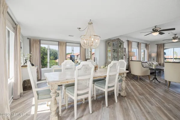 a view of a dining room with furniture window and wooden floor