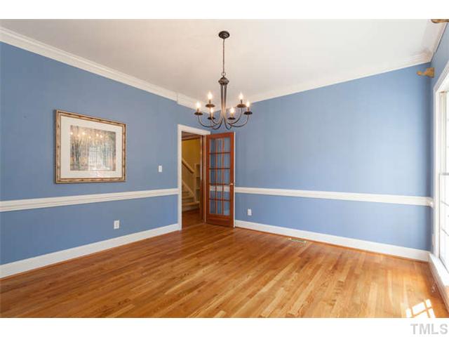 2404 Eddystone Road Raleigh, NC 27612 - Photo 3 of 25 a view of a room with window chandelier fan and wooden floor