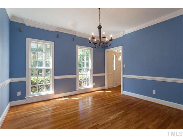 2404 Eddystone Road Raleigh, NC 27612 - Photo 4 of 25 a view of an empty room with wooden floor and a window