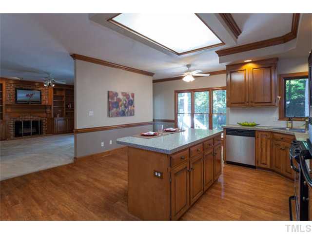 2404 Eddystone Road Raleigh, NC 27612 - Photo 10 of 25 a kitchen with stainless steel appliances granite countertop a stove a sink and a refrigerator
