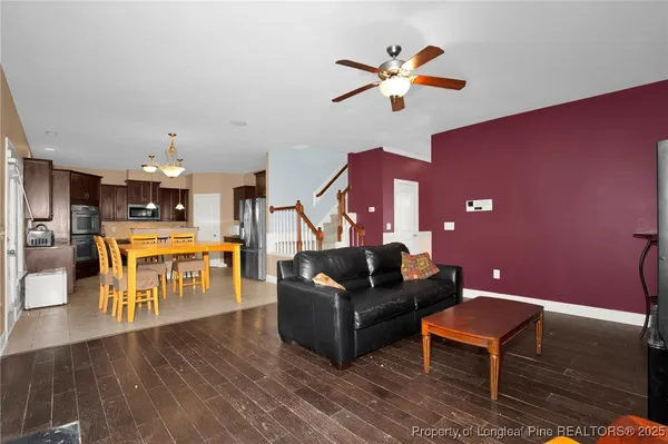 a living room with furniture and kitchen view
