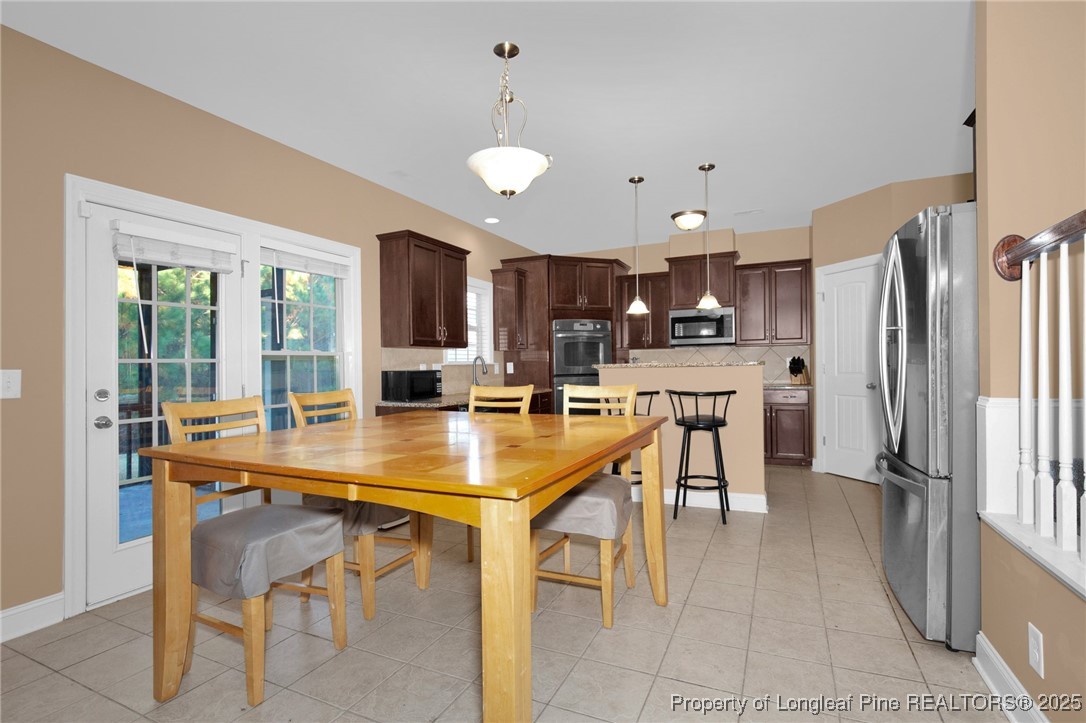 131 Revolutionary Road Cameron, NC 28326 - Photo 14 of 46 a dining table chairs window and stainless steel appliances