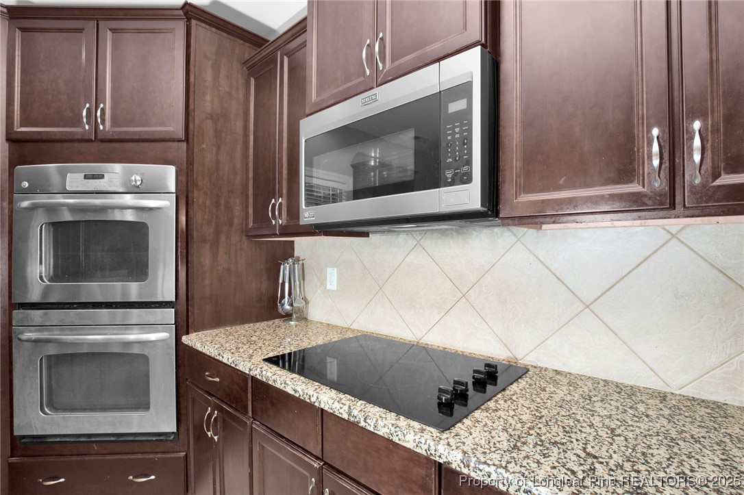 131 Revolutionary Road Cameron, NC 28326 - Photo 17 of 46 a kitchen with granite countertop a sink and a microwave