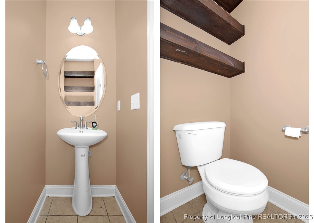 131 Revolutionary Road Cameron, NC 28326 - Photo 20 of 46 a bathroom with a toilet a sink and a mirror