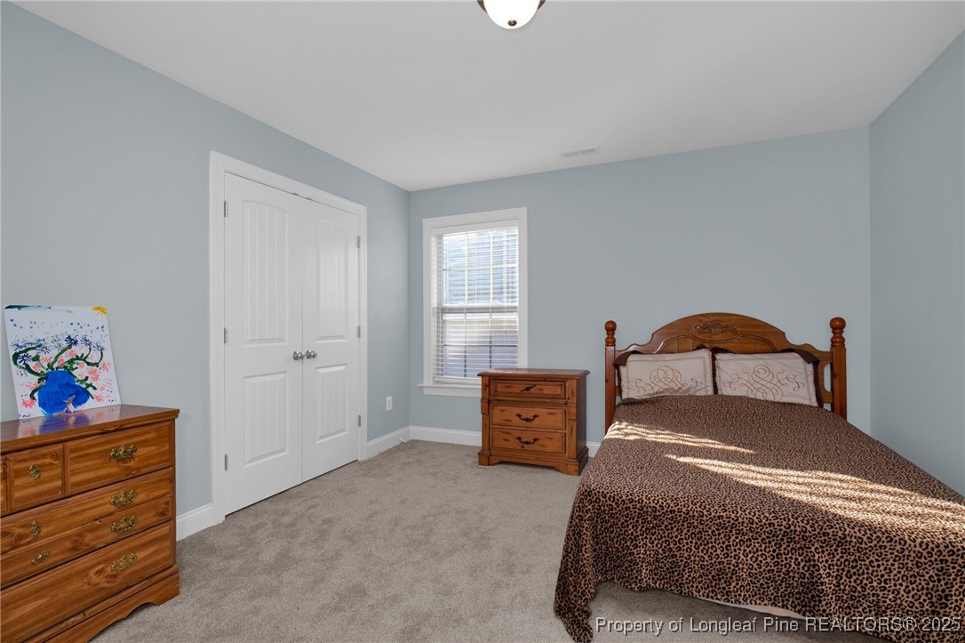131 Revolutionary Road Cameron, NC 28326 - Photo 28 of 46 a bedroom with a bed and a dresser in it