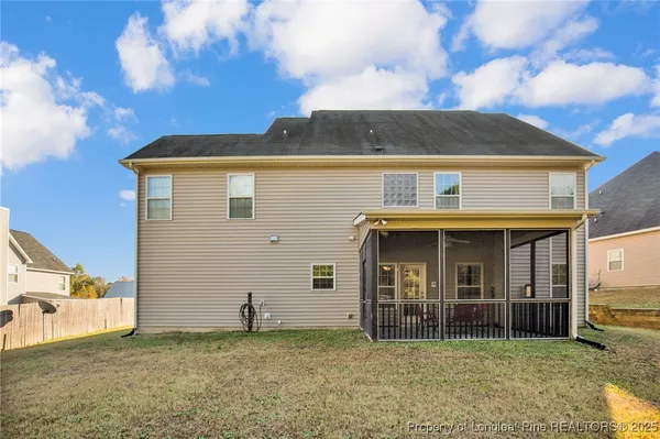 a view of a house with yard and porch