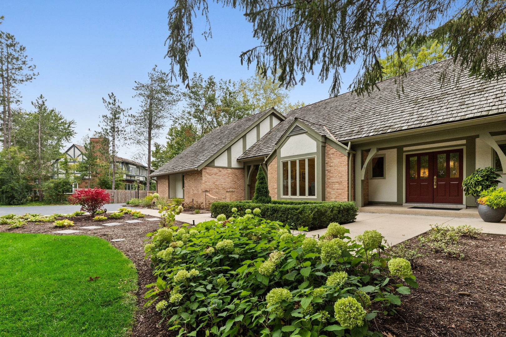675 Rockefeller Road Lake Forest, IL 60045 - Photo 2 of 31 a front view of a house with a yard and potted plants