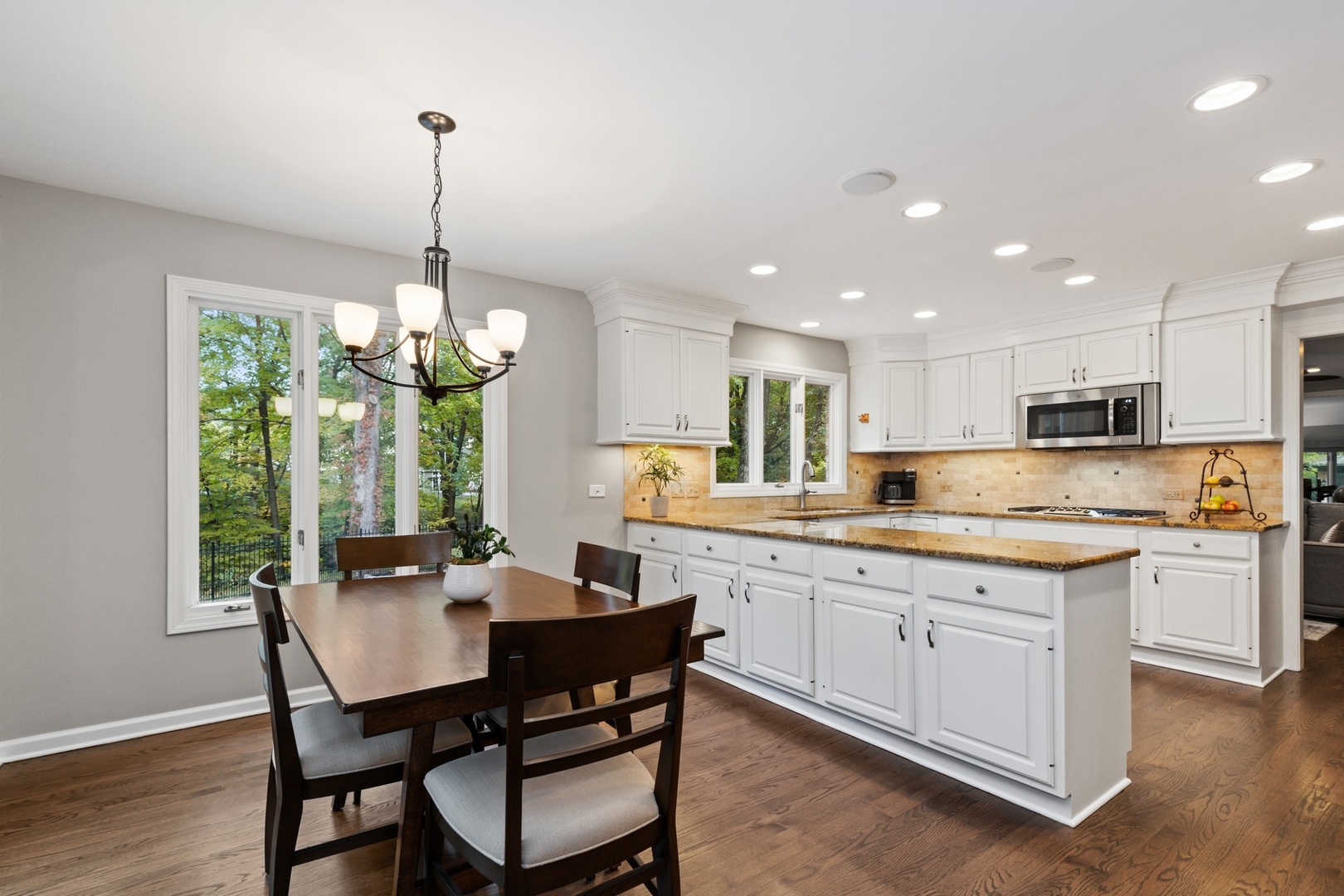 675 Rockefeller Road Lake Forest, IL 60045 - Photo 10 of 31 a kitchen with stainless steel appliances kitchen island granite countertop a table and chairs in it