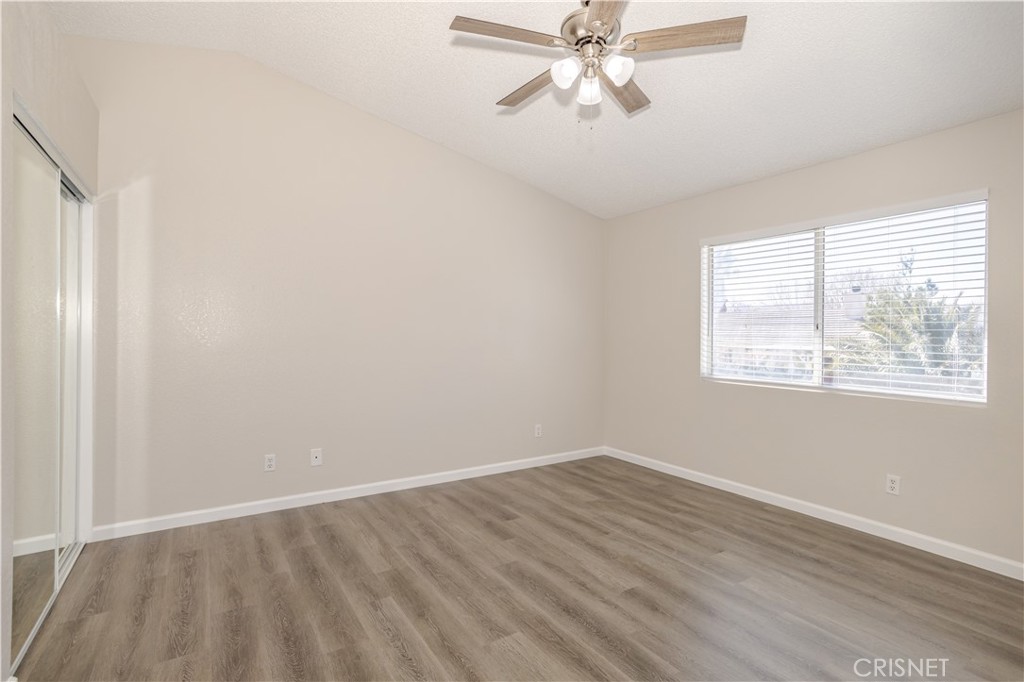 4224 Sorrell Avenue Palmdale, CA 93552 - Photo 17 of 34 a view of an empty room with wooden floor and a window