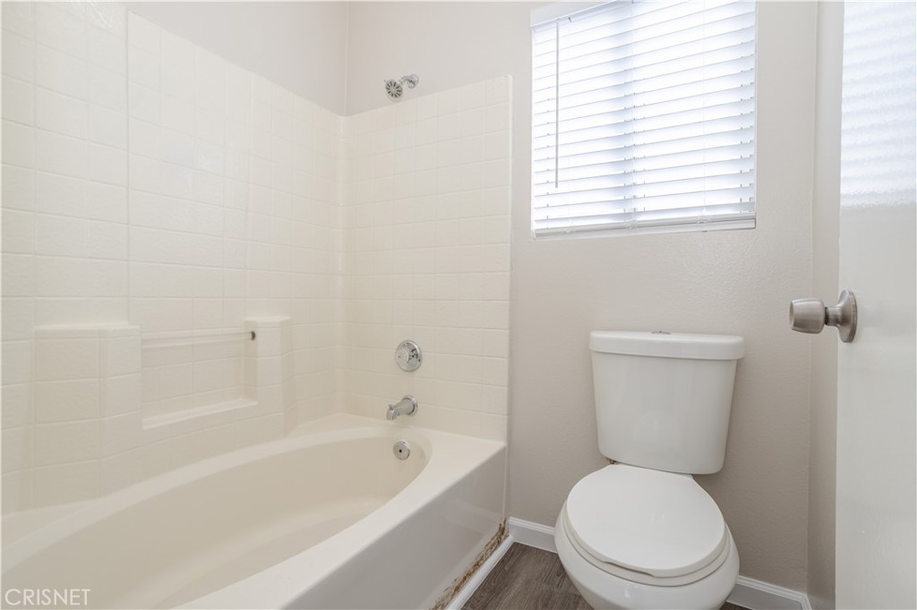 4224 Sorrell Avenue Palmdale, CA 93552 - Photo 22 of 34 a white toilet sitting next to a bath tub