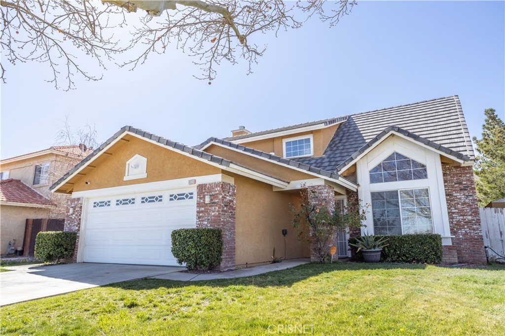 4224 Sorrell Avenue Palmdale, CA 93552 - Photo 3 of 34 a front view of a house with a yard