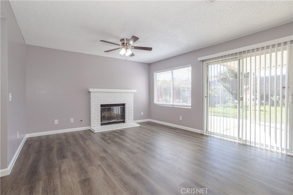 4224 Sorrell Avenue Palmdale, CA 93552 - Photo 9 of 34 a view of an empty room with a window and wooden floor