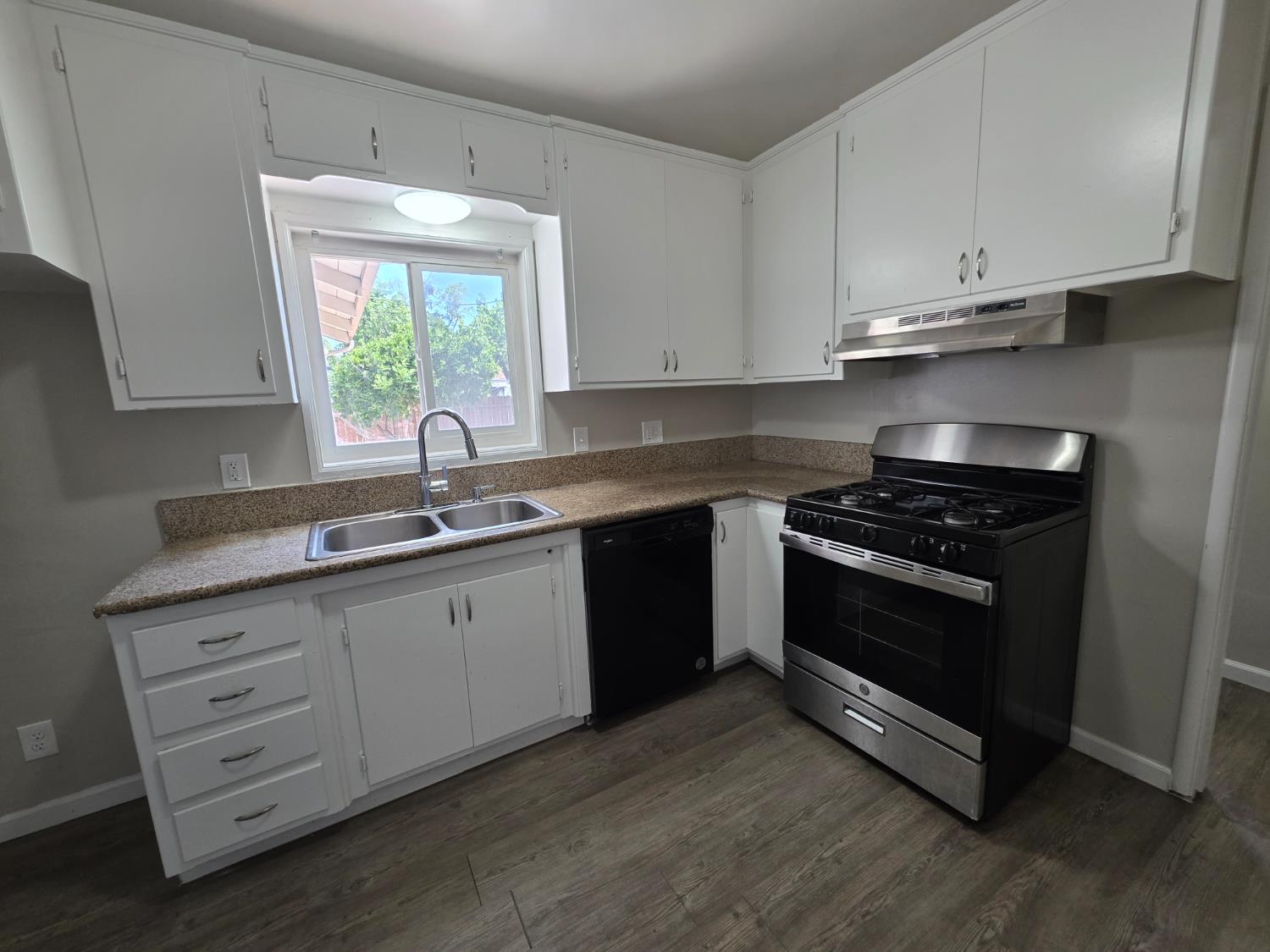 1416 Tully Road Modesto, CA 95350 - Photo 11 of 35 a kitchen with granite countertop white cabinets and appliances