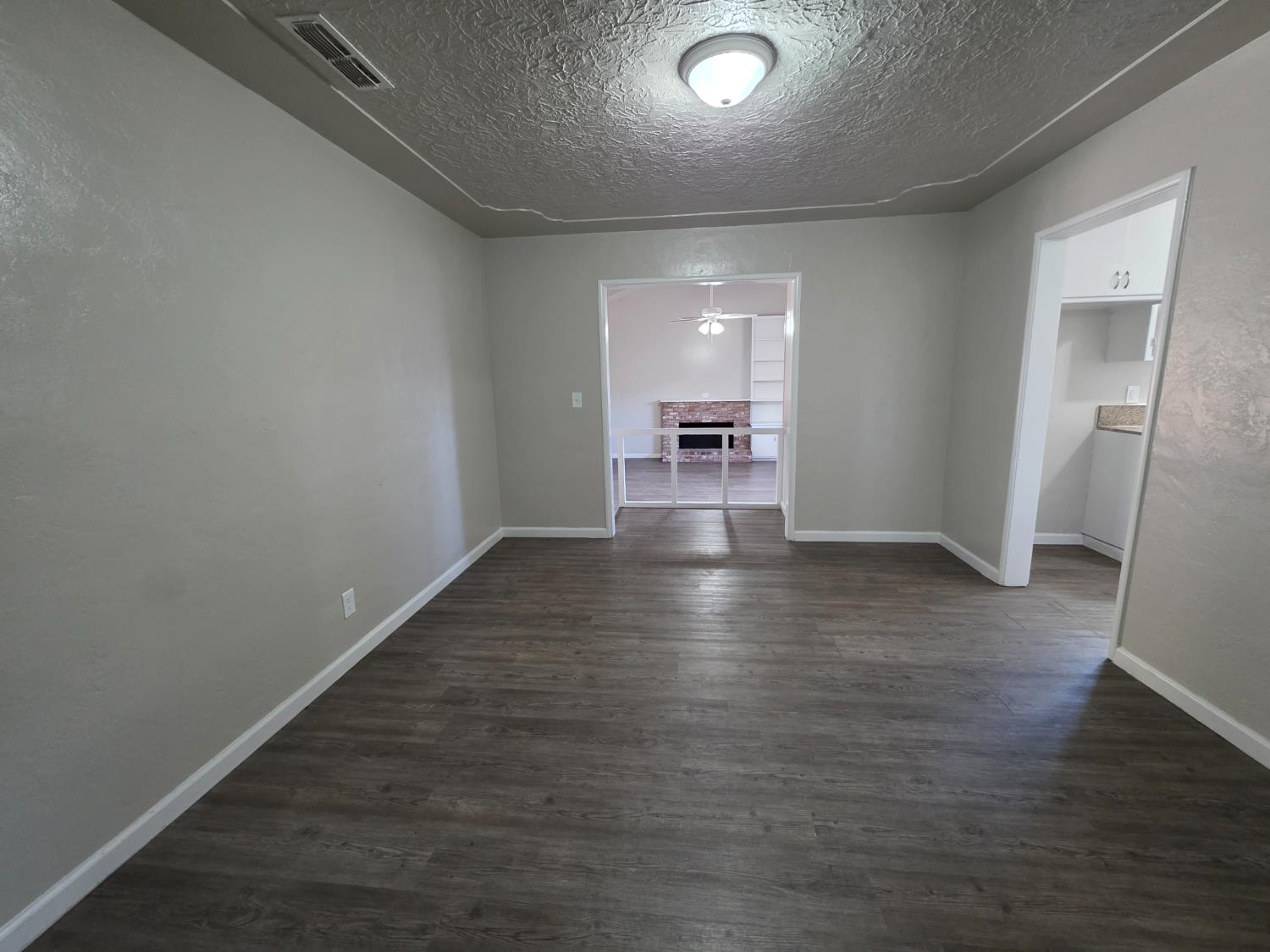 1416 Tully Road Modesto, CA 95350 - Photo 7 of 35 an empty room with wooden floor and a sink