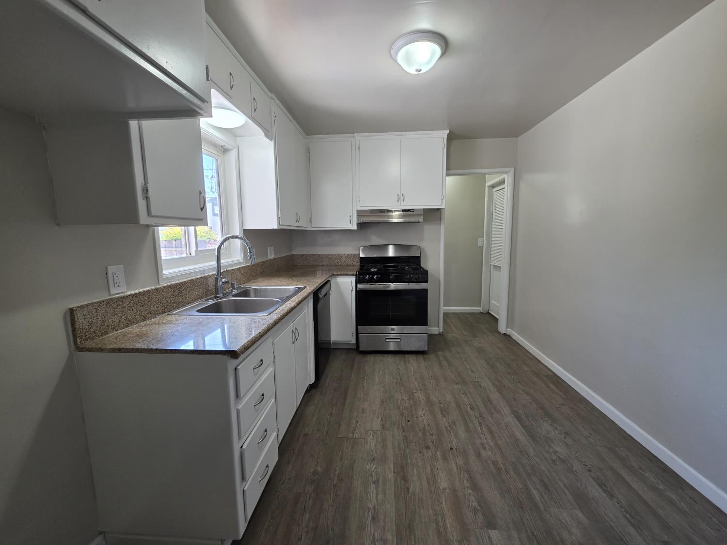 1416 Tully Road Modesto, CA 95350 - Photo 9 of 35 a kitchen with stainless steel appliances granite countertop a sink stove and refrigerator