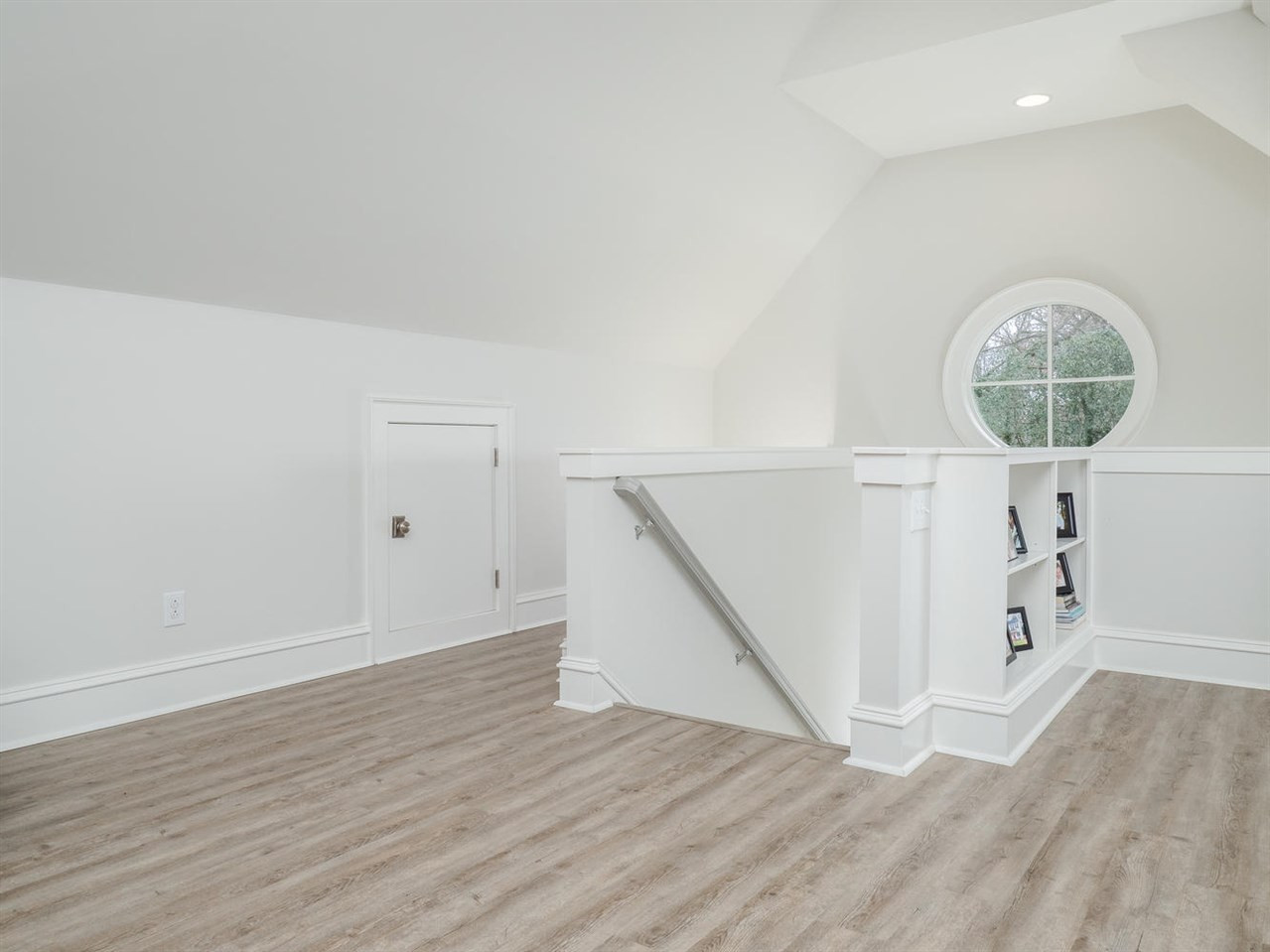 3309 Thomas Road Raleigh, NC 27607 - Photo 25 of 30 This side of the bonus room features built-in book shelves on either side of the stairs, the stylish round window and the back stairs leading to the mudroom. Bonus Room