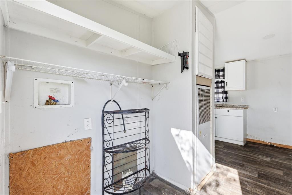 316 Summit Drive Springtown, TX 76082 - Photo 23 of 39 Utility area featuring wall shelving and a white wire shelf