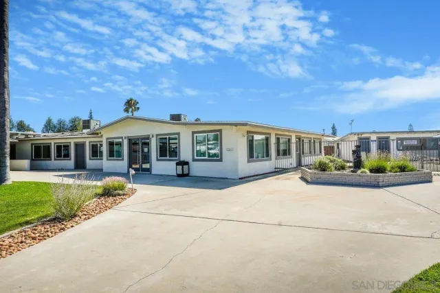 a view of a swimming pool with an outdoor seating and a yard