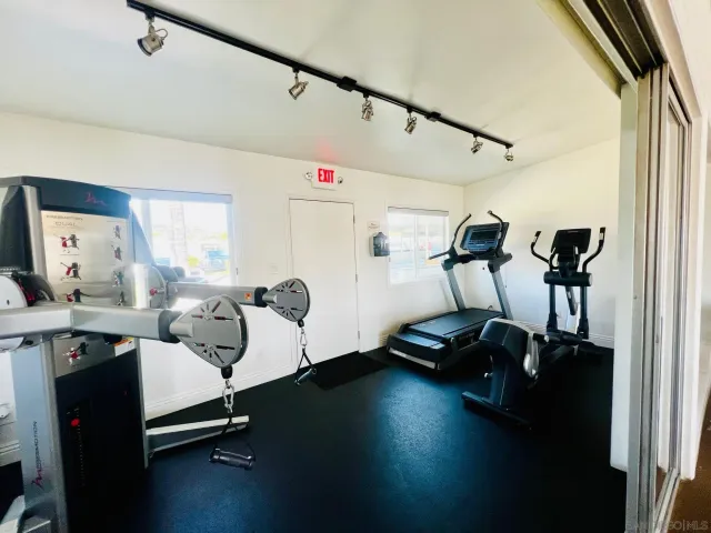 a living room with furniture and view of kitchen