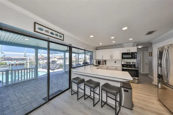 a large kitchen with a table and chairs