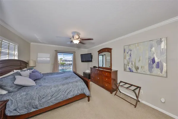 a bedroom with a large bed and a chandelier
