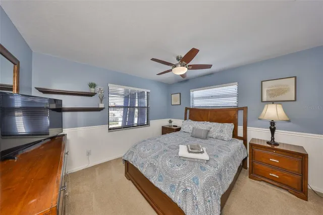 a bedroom with a large bed and a chandelier