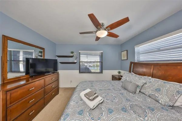 a bedroom with a large bed and a flat screen tv