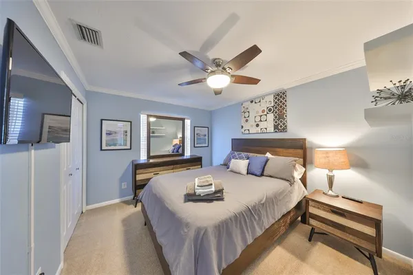 a bedroom with a bed and a chandelier