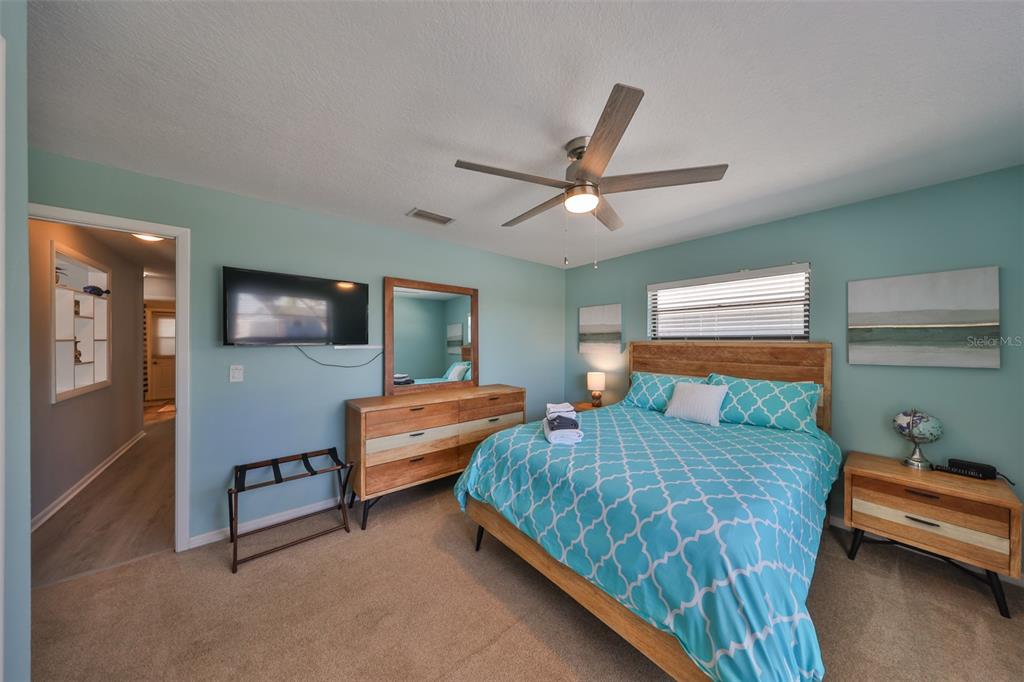 909 Birdie Way Apollo Beach, FL 33572 - Photo 24 of 40 a bedroom with two beds and a flat screen tv