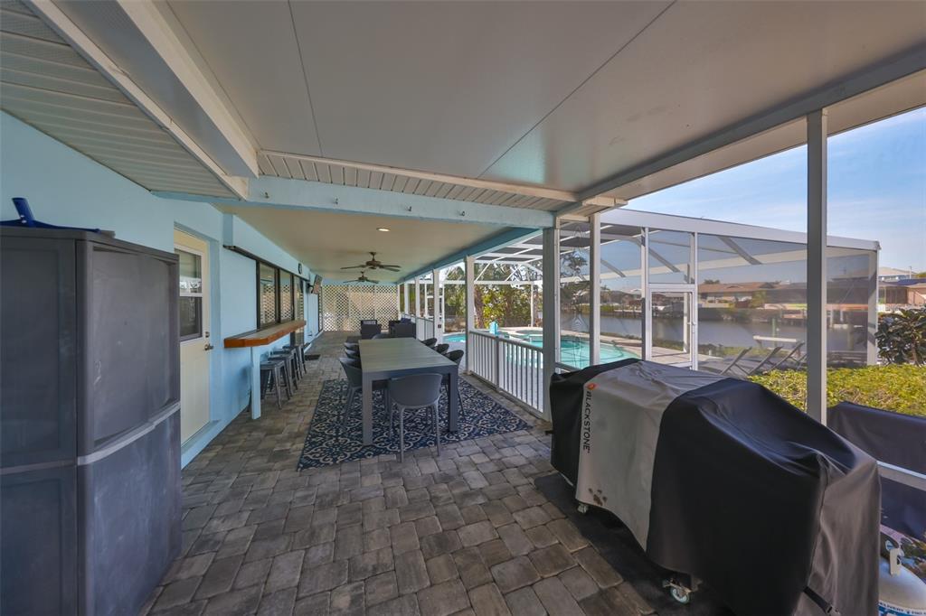 909 Birdie Way Apollo Beach, FL 33572 - Photo 27 of 40 a dining room with furniture a chandelier and fireplace