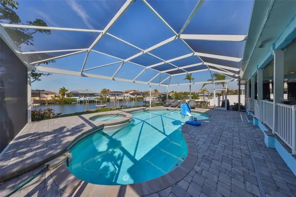 a view of a backyard with table and chairs under an umbrella