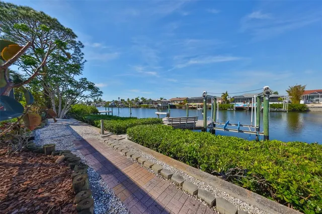 a view of a lake with houses in the back