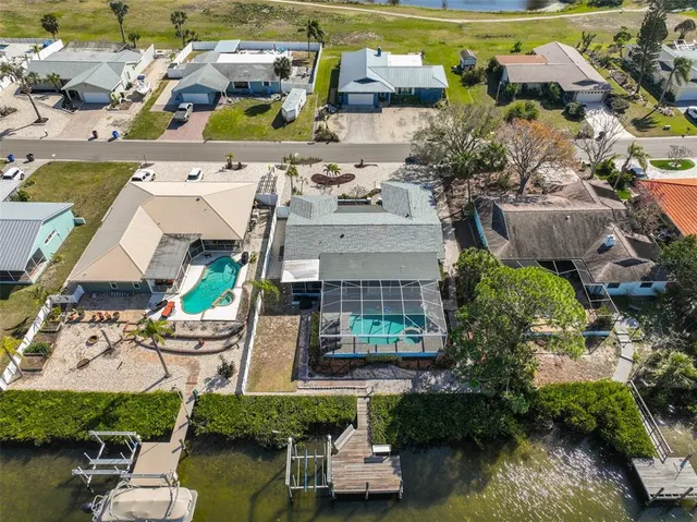 an aerial view of a house with a garden and lake view