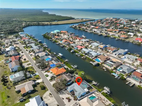 an aerial view of lake and residential houses with outdoor space