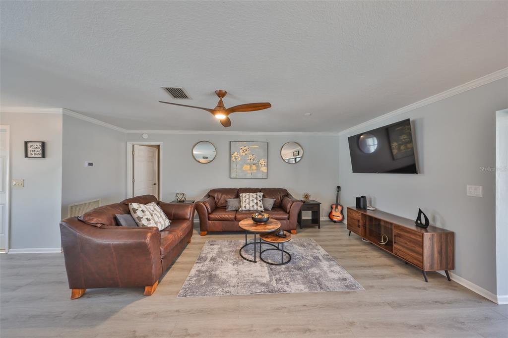 909 Birdie Way Apollo Beach, FL 33572 - Photo 6 of 40 a living room with furniture and a flat screen tv