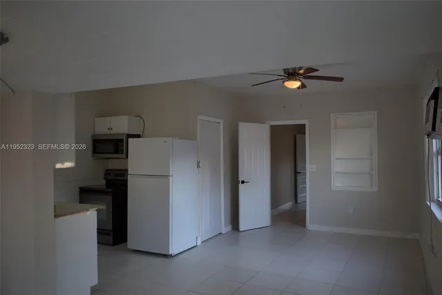 a view of storage and utility room with refrigerator