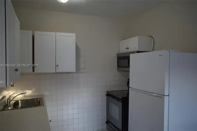 a kitchen with a cabinets and appliances