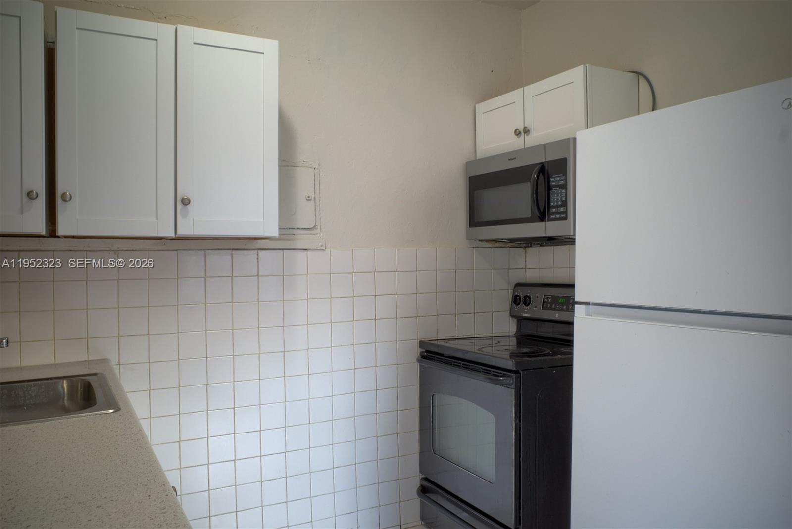 43 Southwest 11th Street, Unit W Dania Beach, FL 33004 - Photo 9 of 23 a kitchen with cabinets and appliances