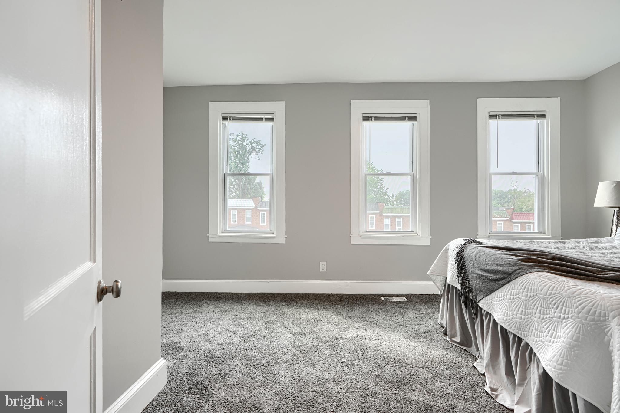 4004 Fairfax Road Baltimore, MD 21216 - Photo 16 of 23 a bed sitting in a room next to a window