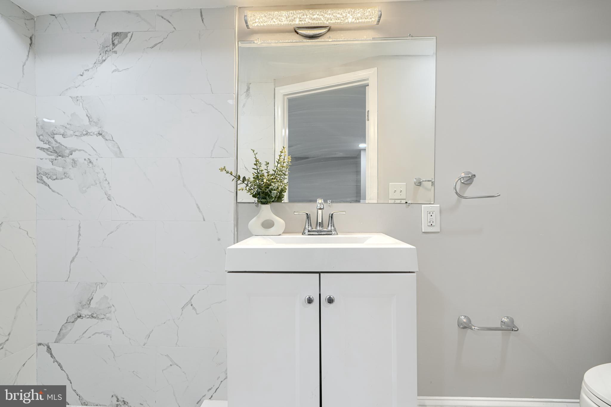 4004 Fairfax Road Baltimore, MD 21216 - Photo 21 of 23 a bathroom with a sink and a mirror