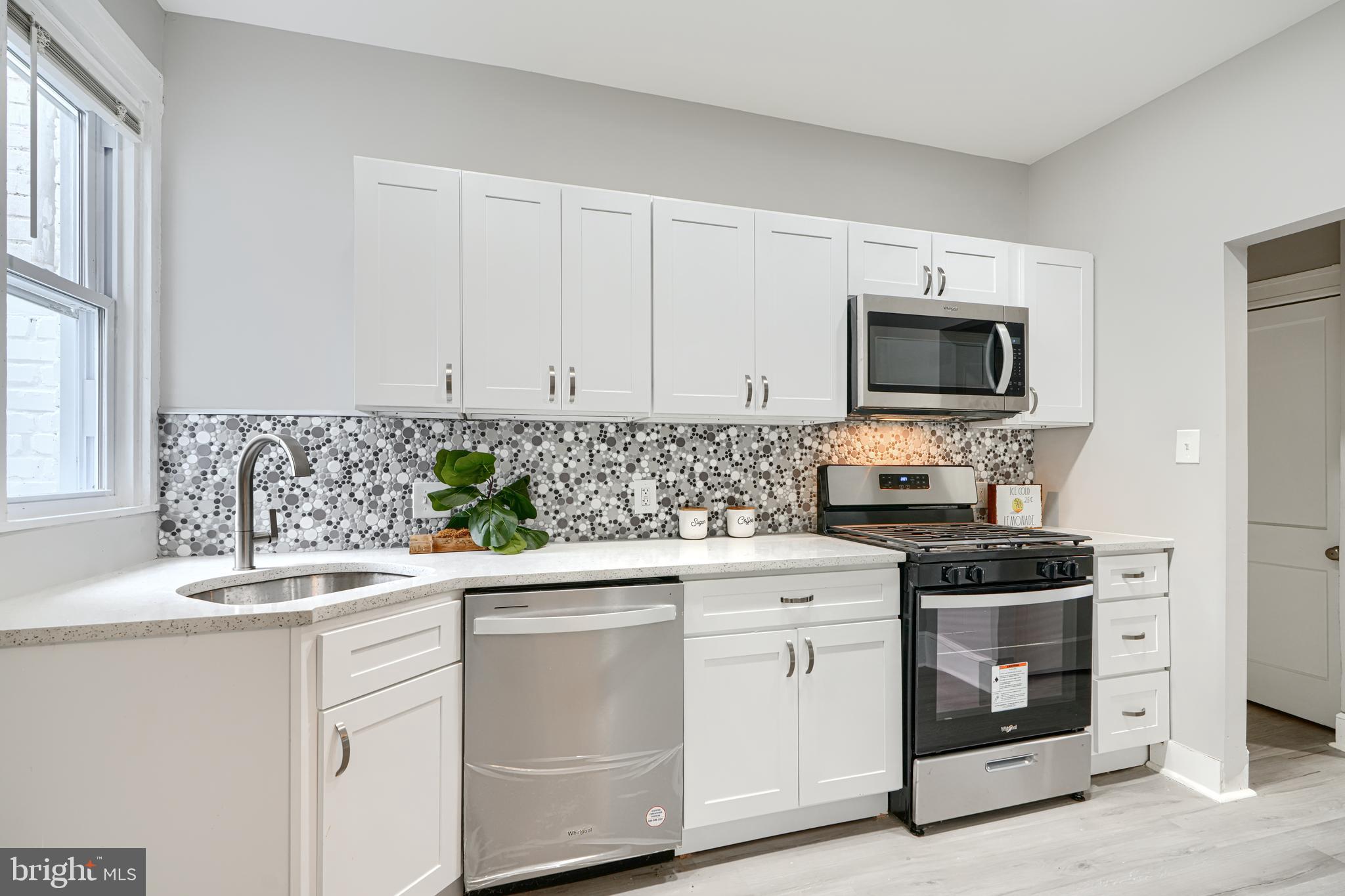 4004 Fairfax Road Baltimore, MD 21216 - Photo 8 of 23 a kitchen with a sink stove and microwave