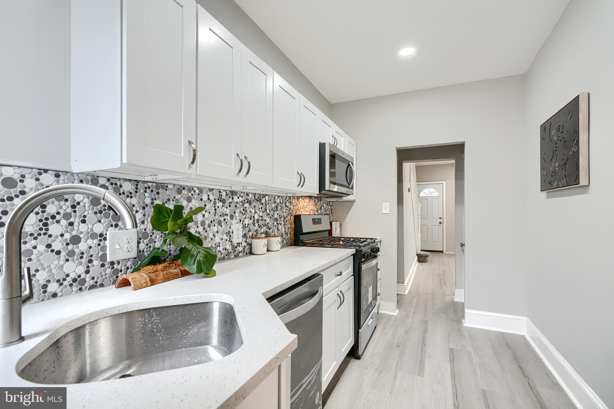 4004 Fairfax Road Baltimore, MD 21216 - Photo 9 of 23 a kitchen that has a sink and a stove