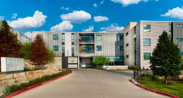 a view of a house with a yard and garden