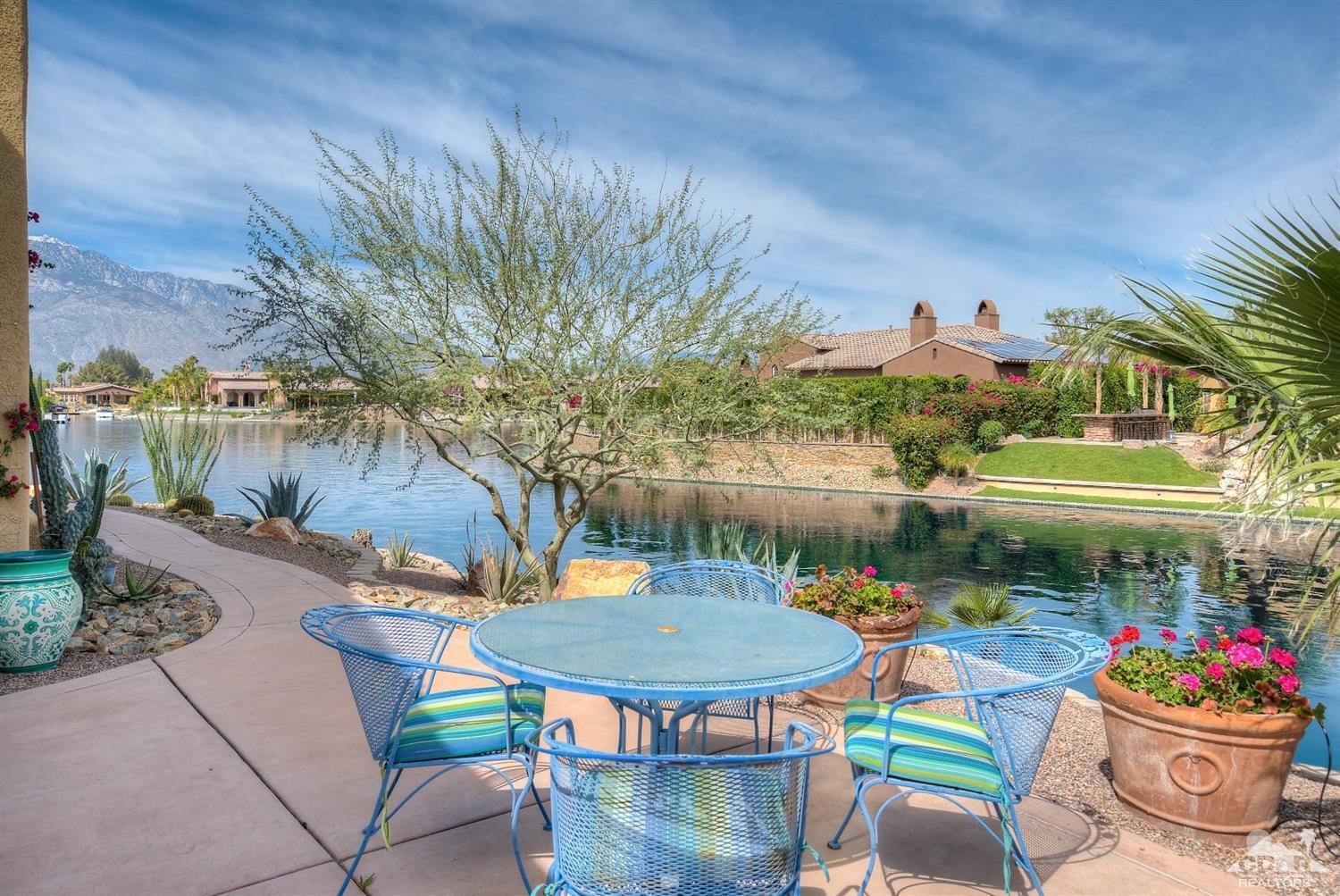10 Via Santa Ramona Rancho Mirage, CA 92270 - Photo 34 of 78 a view of a chairs and table in patio with a lake view