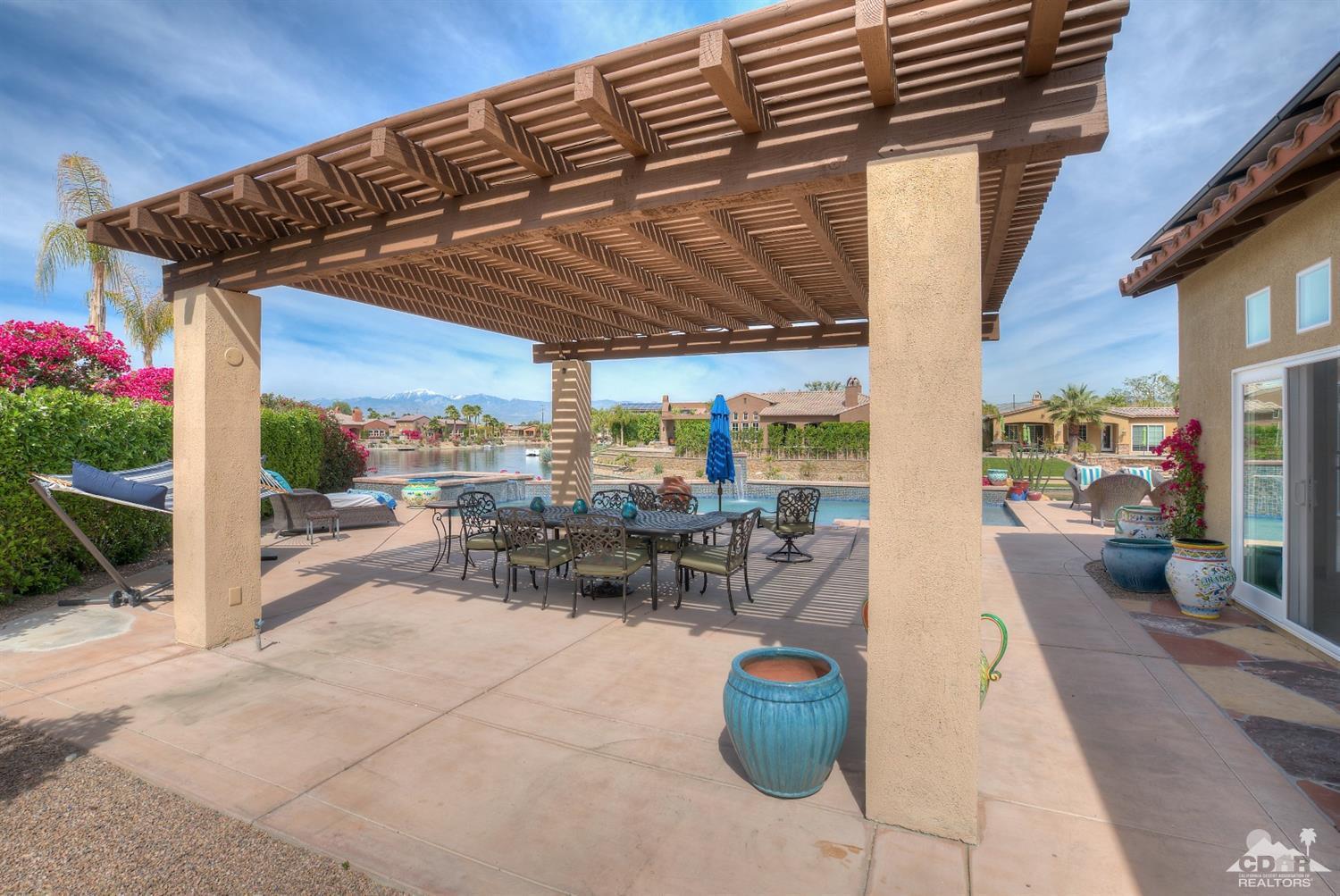 10 Via Santa Ramona Rancho Mirage, CA 92270 - Photo 38 of 78 a view of a patio with a table and chairs and potted plants