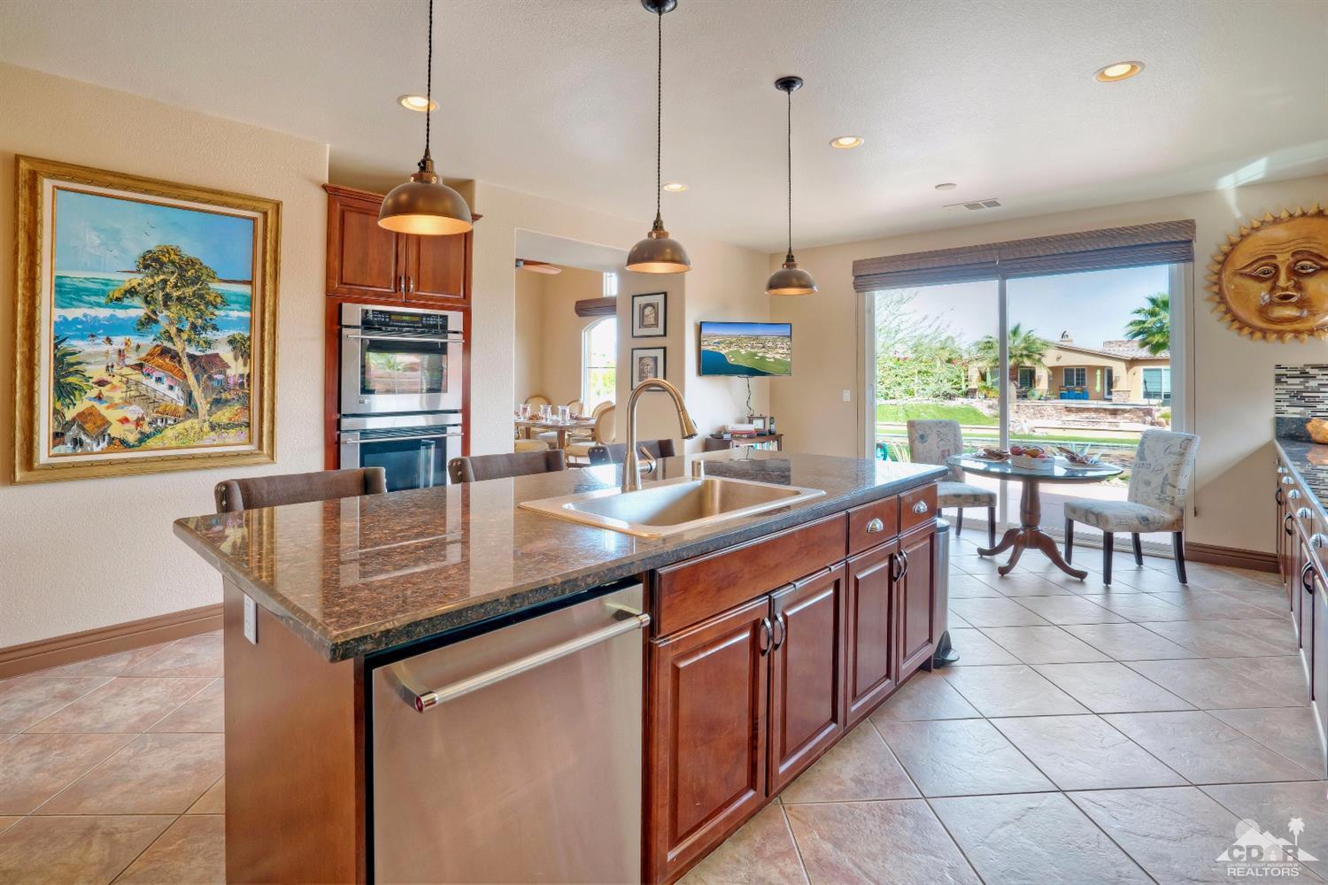 10 Via Santa Ramona Rancho Mirage, CA 92270 - Photo 47 of 78 a kitchen with stainless steel appliances granite countertop a sink a stove and a wooden floors