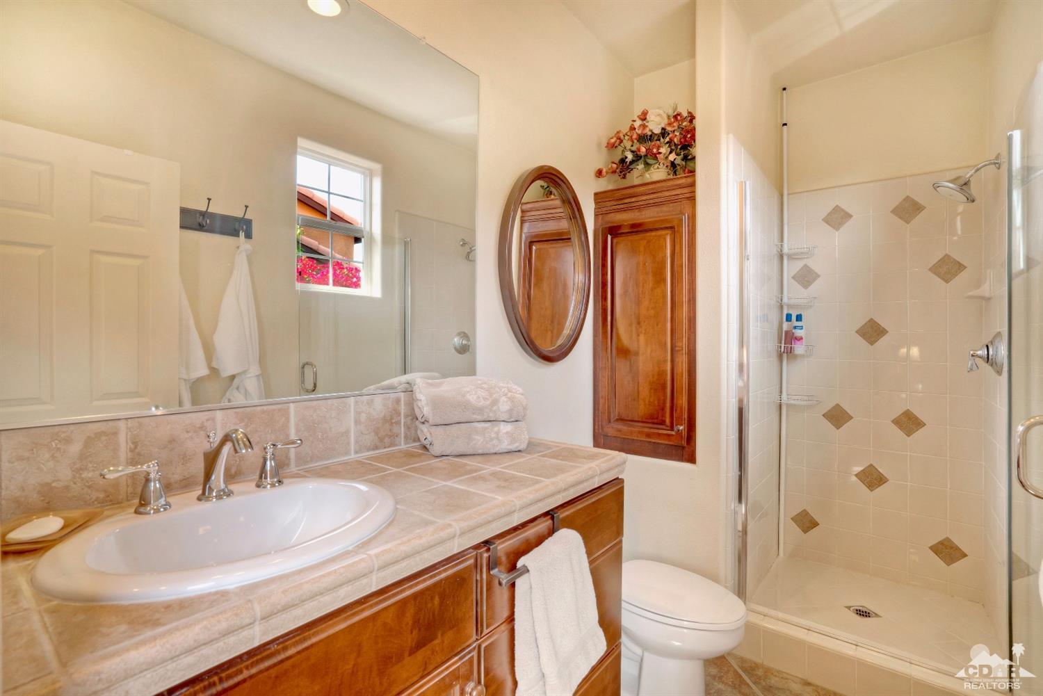 10 Via Santa Ramona Rancho Mirage, CA 92270 - Photo 58 of 78 a bathroom with a granite countertop sink and a mirror