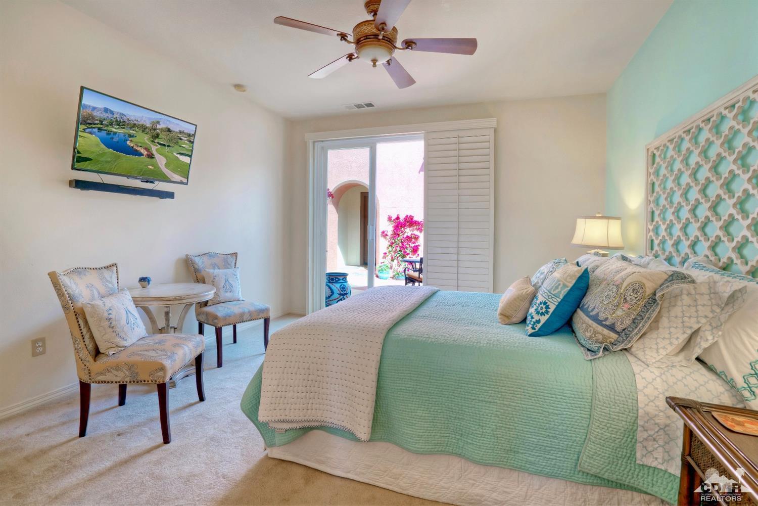 10 Via Santa Ramona Rancho Mirage, CA 92270 - Photo 62 of 78 a bedroom with a bed and a chandelier