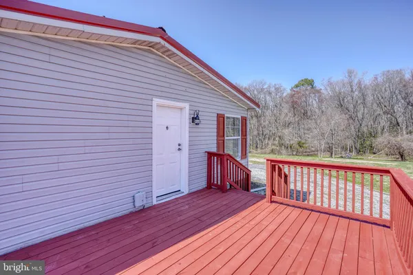 a view of backyard with a deck and wooden floor